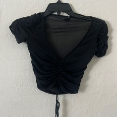 Condition: Never Worn 93% Nylon, 7% Spandex Cute Black Mesh Top Perfect For A Night Out Or A Concert Black Stretch V-neck Crop Top, Black Ruched Nylon Top, Black Elastane Crop Top With Short Sleeves, Black Short Sleeve Elastane Crop Top, Black Polyamide Tops For Night Out, Black V-neck Crop Top For Summer, Black V-neck Crop Top For Spring, Black Nylon Crop Top, Black Stretch Polyamide Tops