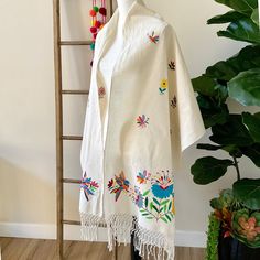 This beautiful hand embroidered rebozo was handcrafted needlework by our artisans partners from Tenango de Doria Hidalgo Mexico. Made with manta fabric and embroidered with the vibrant Mexican colors and motifs of Otomi textiles. lovingly unique, unrepeatable. One of -a-kind Details: Manta 100% 100% HandEmbroidered All items are ship from US. All Mi Mundo Mexicano items are 100% handmade by artisans in Mexico. Each stitch and item is completely unique and one-of-a-kind, so you'll never find two Multicolor Embroidered Cotton Fabric For Traditional Ceremonies, One Size Embroidered Folk Shawl, Embroidered Folk Shawl One Size, One Size Folk Embroidered Shawl, Bohemian Cotton Fabric For Traditional Ceremonies, Traditional Embroidered One Size Shawl, Traditional Embroidered One-size Shawl, Bohemian Cotton Shawl With Embroidered Border, Bohemian Embroidered Shawl Fabric