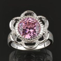 a pink and white diamond ring on a black background