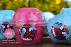 there are three plastic containers with spiderman designs on them and one has an apple in it