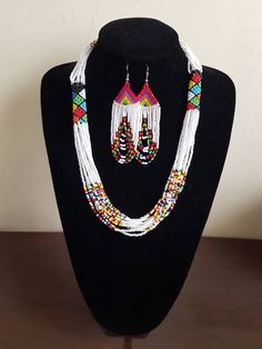 "Necklace comes with matching earrings. Dimensions: 27\" Main color: white Available in different colors.  More necklaces here; https://www.etsy.com/shop/PrimeBeadsKe?ref=seller-platform-mcnav&section_id=33399833 All items are shipped through dhl express!" White Beaded Jewelry Sets As Gift, White Beaded Jewelry Set Gift, White Beaded Jewelry Set As A Gift, White Beaded Jewelry Set For Gift, White Jewelry With Round Beaded Chain, White Bohemian Jewelry With Dangling Beads, White Bohemian Jewelry With Large Beads, White Beaded Chain For Jewelry Making, Bohemian White Beaded Earrings With Chain