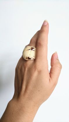 A unique elegant chunky ring, handmade from natural Tagua nuts. Vegetable Ivory, dark white ring with a combination of natural black color and a glossy, shiny finish. A cocktail-style jewelry piece, easy to be worn with a casual or a statement outfit. A big ring boho style with a beautiful natural color combination. It is lightweight and wonderfully comfortable. An eco-friendly jewelry hand carved from real nuts collected, sustainably from South America. Comes in a selection of sizes. Jewelry is Big Rings Boho, Big Statement Rings, Rustic Ring, Jewelry Classic, Rustic Rings, Carved Ring, Unusual Rings, Tagua Nuts, Cocktail Accessories