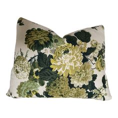 a floral pillow with green and yellow flowers on it