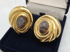 Hello and welcome to my shop. I am  offering to you this superb pair of vintage retro period clip on costume jewelry earrings. As you will see in the pictures the earrings are made in with an oval smooth raised work paterned edge and each is set with a mottled mixed coloured faux moss agate type oval stone. Both the earring back clip fastners are in good working order. The goldtone and faux agate oval earrings are in an excellent used vintage condition with no or only very slight age related sur Faux Moss, Costume Jewelry Earrings, Oval Earring, Oval Stone, Agate Stone, Earring Backs, Costume Jewelry, Clip On Earrings, Favorite Jewelry