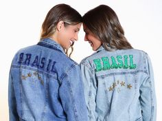 two women wearing jean jackets with the words brasil on them