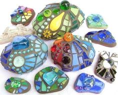 many different colored glass pieces on a white surface