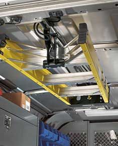 the inside of a van with yellow ladders