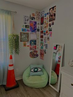 a room with pictures on the wall and a bean bag chair in front of it