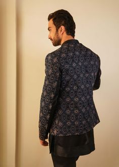 Editor's Note Featuring Our Bestseller Short Jacket, Now In A Midnight Blue Color. After Being A Hero Outfit For Consecutive Two Seasons, We Are Now Showcasing The Jamawar Embroidered Short Jacket With Dabka Highlighting, In Our New Color. Paired With Short Embroidered Hem Kurta With Tapered Trousers. Fabric: Linen Silk Color: Blue Component: Short Jacket, Kurta. Trousers Care: Dry Clean Only About the Designer After establishing himself as the leading couturier in the industry of menswear, Jati Winter Party Bandhgala With Long Sleeves, Winter Party Long Sleeve Bandhgala, Long Sleeve Nehru Jacket For Party In Winter, Blue Stand Collar Blazer For Formal Occasions, Formal Blue Stand Collar Blazer, Blue Tailored Long Sleeve Nehru Jacket, Tailored Blue Nehru Jacket, Tailored Blue Nehru Jacket With Long Sleeves, Festive Blue Long Sleeve Blazer