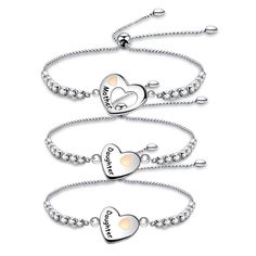 three silver bracelets with two hearts on them