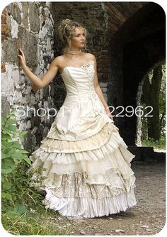 a woman in a wedding dress leaning against a stone wall