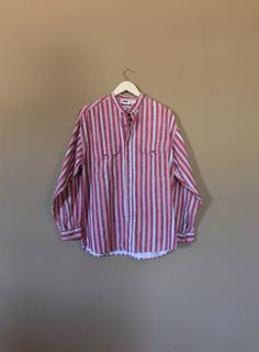 Authentic vintage long sleeve shirt with 90s stripe design. Dates from early to mid 90's. This shirt is in great condition with little signs of previous wear. Full button up front. Long sleeves can be buttoned at wrist or rolled up. Still has many years of wear left. Check out my shop 'TheBarnLadder' for reviews and feedback Measurements (taken zipped-buttoned up and laid comfortably flat) x2 for circumference Size Small Shoulders 40-42 Bust 42 Bottom hem circumference 42 Sleeve 22 Top arm circu Oversized Long Sleeve Retro Shirt, 90s Style Relaxed Fit Button-up Top, 90s Style Cotton Shirt For Spring, Oversized Retro Shirt For Spring, 90s Inspired Long Sleeve Cotton Top, 90s Style Cotton Shirt For Fall, 90s Style Cotton Button-up Shirt, 90s Cotton Collared Shirt, 90s Style Button-up Tops For Spring