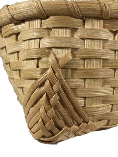 a close up of a woven basket on a white background