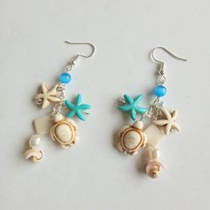 Marine theme handmade earrings, cute ocean inspired jewellery, ideal gift for her, sea themed earrings, lovely summer item. Sea themed item represent shell earrings with sea stars and turtle beads. Blue cat's eye beads (4 mm) add the charm of summer sea beach. Those nautical dangle & drop earrings are perfect for all occasions, wear this pair of earrings with traditional or modern outfit, say,  on beach summer cocktail party or during your city beach walk. Drop length is approx. 5.0 cm. All earrings metal parts are nickel-free and silver plated. Please, pay attention to FAQs and if you have any question, don't hesitate to ask.  Thanks for visiting my shop! Cheap White Ocean-inspired Earrings, Cheap Colorful Earrings For The Beach, Beach Artisan Earrings, Ocean Earring Stack, Sea Themed Earrings, Coastal Earrings, Summer Cocktail Party, Ocean Earrings, Ocean Inspired Jewelry