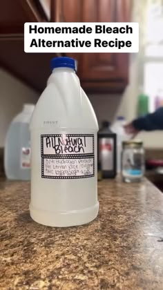 a bottle of white liquid sitting on top of a counter