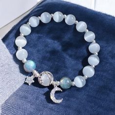 ✨ Elevate your style with our Handmade Beaded Bracelet featuring delicate Star and Moon dangling charms! Available in two stunning styles -- clear beads for a minimalist, ethereal vibe, or purple beads for a touch of mystical elegance. 🌙💫 Each bracelet is meticulously crafted with high-quality beads that shimmer in the light, paired with celestial-inspired charms that add a dreamy, cosmic touch. Whether you're drawn to the clarity of the clear beads or the deep allure of the purple, this brace Silver Beaded Star Bracelets, Celestial Style Adjustable Beaded Bracelets With Round Beads, Adjustable Celestial Bracelets With Round Beads, Adjustable Celestial Bracelet With Round Beads, Adjustable Celestial Beaded Bracelets With Round Beads, Celestial Style Beaded Bracelets As Gift, Handmade Celestial Beaded Bracelets With Round Beads, Silver Beaded Bracelets With Moon Charm As Gift, Moonstone Beaded Bracelet As Gift