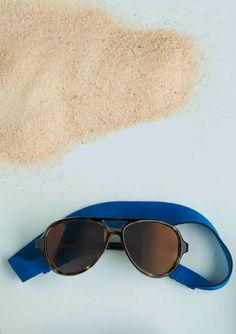 This pair of sunglasses feature tortoise and blue details. It comes with a removable neoprene neck strap and is intended for ages 0-2 years. Pastic UV400 Protection Polarized Aviator Sunglasses For Summer Outdoor Activities, Summer Outdoor Aviator Sunglasses With Adjustable Fit, Brown Adjustable Sunglasses For Beach, Adjustable Brown Sunglasses For The Beach, Adjustable Sunglasses For Summer Travel, Sporty Sunglasses With Uva Protection For Beach, Adjustable Aviator Sunglasses With Uva Protection For Beach, Adjustable Sunglasses With Uv Protection For Beach, Beach Sunglasses With Uv Protection And Adjustable Fit