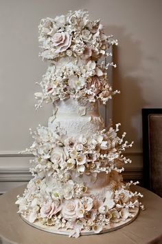 a white wedding cake with flowers on top