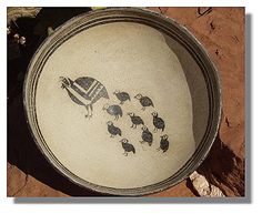 a bowl with birds drawn on it in the dirt