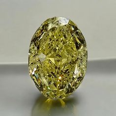 a fancy yellow diamond sitting on top of a table