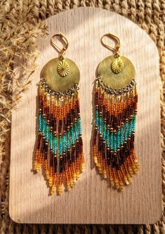 Beaded native earrings handmade with glass beads, brass, hematite, and gold plated leverbacks. Stone: 18k gold plated hematite Beads: Czech Leverbacks: 18k gold plated brass Drop Height: 4.5 in. Nickel Free Aisholpan is the first girl to win the male-dominated Eagle Hunter Competition in Mongolia. Beaded Earrings Native Beadwork Moon & Milk, Artisan Multicolor Beaded Earrings With Gold Beads, Festival Brass Beaded Earrings, Bohemian Gold Earrings With Beaded Chain, Artisan Gold Beaded Earrings, Gold Heishi Beads Earrings, Gold Beaded Dangling Earrings For Festival, Gold Dangling Heishi Beads Earrings, Gold Beaded Festival Earrings