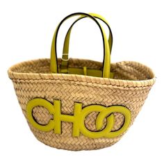 Elevate your summer style with the Jimmy Choo Logo Crossbody Tote Bag, crafted from natural raffia with citron yellow leather trim. This chic tote features the iconic Jimmy Choo logo detailing, two leather handles, and a convenient tie closure. Its interior is unlined keeping the natural raffia consistent throughout the bag and includes one pocket for organization.  Perfect for any occasion, this bag combines luxury with practicality. Add a touch of sophistication to your look with Jimmy Choo's Jimmy Choo Logo, Yellow Trim, Jimmy Choo Bag, Crossbody Tote Bag, Yellow Leather, Crossbody Tote, Leather Handles, Leather Trim, Womens Tote Bags