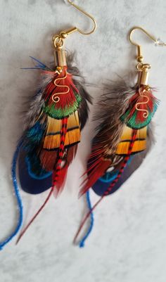 This unique long Bohemian earrings is perfect gift for her. This  hand made feather earrings they are modern elegant and made just a little bit different.  If u are on the hunt for the perfect handmade jewelry that will hold its meaning for years to come you landed  in right place. Perfect for weddings / bridesmaids gifts / parties, birthday gifts, fancy dress.    This customizable earrings makes the perfect gift for mom.   This listing is for 1 pair of your choosing :  -navy  -  yellow Making Feather Earrings, Native Feather Earrings, Multicolor Feather Jewelry For Festivals, Bohemian Peacock Design Earrings For Party, Multicolor Peacock Design Earrings For Gift, Multicolor Peacock Design Earrings As Gift, Bohemian Peacock Earrings For Gift, Bohemian Peacock Earrings As Gift, Peacock Bohemian Earrings For Gift