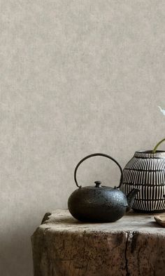 two black and white vases sitting on top of a table