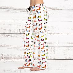 Add custom style to any loungewear collection with these custom-printed  Dachshund pajama pants. Their 100% polyester jersey knit fabric, along with the relaxed fit, makes for the ultimate comfort choice while kicking back at home. Meanwhile, the back elastic with the drawstring tie creates the perfect fit while the all-over-print adds a stylish dimension unique to your taste.  .: 100% polyester .: White seam thread .: Light fabric (6 oz/yd² (203 g/m .: Relaxed comfort fit .: Back elastic and black drawstring tie .: Sewn-in care label .: Assembled in the USA from globally sourced parts                                  XS           S          M          L          XL        2XL Waist width, in13.5014.4915.5116.7317.9919.25 Outseam, in       39.2540.0040.2440.6340.9841.38 Inseam, in      29. Multicolor Cotton Sleepwear Pants, Multicolor Cotton Sleepwear Long Pants, Printed Cotton Bottoms For Pajama Party, Cotton Printed Bottoms For Pajama Party, Playful Cotton Sweatpants For Loungewear, Multicolor Cotton Sleep Pants, Playful Multicolor Pants For Loungewear, Playful White Pants For Loungewear, Playful Multicolor Loungewear Pants