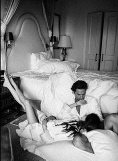 black and white photograph of two people laying in bed