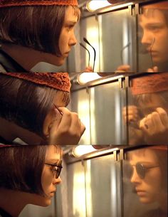 two mannequins with hair tied to their heads in front of a mirror