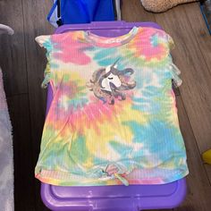 Beautiful, Multicolor, Tie-Dye, Short Sleeve, Top With Fluffy Sleeves, And A Unicorn And Sequins On The Front Of The Shirt With A Bow At The Waist. Brand New Item Without Tags. Cute Multicolor Tops With Rainbow Print, Cute Multicolor Rainbow Print Tops, Cute Tie Dye Crew Neck Top, Cute Tie-dye Crew Neck Top, Playful Tie Dye Cotton Tops, Playful Tie Dye Short Sleeve T-shirt, Playful Tie-dye Short Sleeve T-shirt, Playful Cotton Tie Dye Tops, Playful Cotton Tie-dye Tops