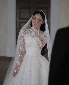 the bride is covering her face with her hands