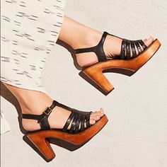 Free People Haven Clog Strappy Leather Clogs Featuring An Adjustable Ankle Strap. Wood Platform Padded Footbed Rubber Outsole Care/Import Import Measurements Heel: 4 In Color: Black, Runs Small Black Round Toe Summer Clogs, Black Round Toe Clogs For Summer, Black High Heel Clogs For Spring, Chic Medium Width Wedge Heel Clogs, Black Wedge Heel Clogs For Summer, Chic High Heel Clogs With Heel Strap, Black Wedge Heel Clogs For Spring, Chic Ankle Strap Clogs With Wooden Heel, Chic Ankle Strap Clogs With Buckle Closure