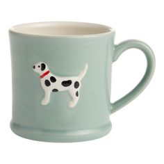 a coffee cup with a dog on it's side and a red collar around its neck