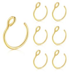 six pairs of gold plated metal hoops with twisted ends, all in different sizes