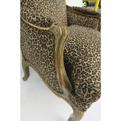 a leopard print chair with gold trim