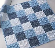 a blue and white afghan with hearts on it