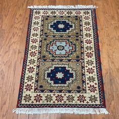 Add warmth and character to your home decor with this one-of-a-kind Kazak wool rug. Handmade in India by skilled weavers, this rug features a vibrant blend of red, navy, gold, ivory, gray, and pink hues. Navy Gold, Rug Store, Rug Handmade, Rugs Online, Bed Bath Beyond, Bed Bath, Wool Rug, Bed Bath And Beyond, Area Rugs