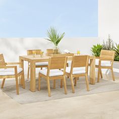 a wooden table and chairs on a patio