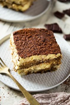 a piece of cake sitting on top of a plate next to a fork and knife