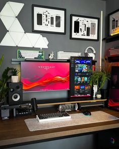 a computer desk with two monitors and speakers