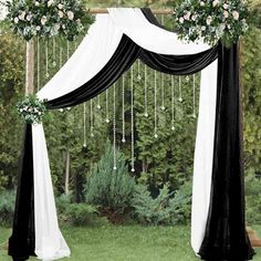 a black and white wedding arch decorated with flowers