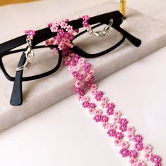 This handmade pink flower glasses chain is carefully hand-woven from the highest quality glass seed beads! Lenght 70 cm ( 27 inches ) It is not only a sweet sunglasses chain, but also a multi-purpose flower glasses chain that you can use as a daisy long necklace, wrap bracelet, cute reading glasses! It is an eyewear cord that is compatible with all your clothes that you can use in all seasons! Guaranteed to get all the compliments! It is the ideal handmade gift jewelry and accessory for you and Elegant Pink Glasses Chain As Gift, Elegant Pink Glasses Chain Gift, Handmade Adjustable Pink Glasses Chains, Adjustable Pink Glasses Chains As Gift, Handmade Pink Glasses Chains For Summer, Handmade Pink Glass Glasses Chains, Adjustable Pink Glass Glasses Chains, Pink Adjustable Glasses Chains For Gift, Pink Adjustable Glasses Chains As Gift