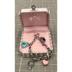 Pictured Is A Juicy Couture Enameled Charm Bracelet W/ Original Box The Bracelet Is 7 1/4" Looks Never Worn Size: Womens 7 1/4" Condition: Pre-Owned Looks As If Never Used Designer Enamel Bangle Jewelry, Designer Enamel Jewelry As A Gift, Designer Enamel Jewelry For Gift, Luxury Pink Jewelry Collectible, Luxury Pink Collectible Jewelry, Designer Bangle Jewelry For Gift, Designer Bangle Jewelry As Gift, Luxury Silver Enamel Bracelets, Luxury Metal Charm Bracelet As A Gift