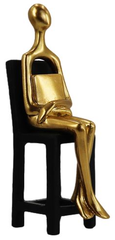 a gold statue sitting on top of a black chair