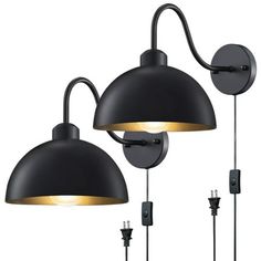 two black wall lights with one light on each side and the other off to the side