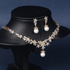 Elegant and sophisticated bridal necklace set with a gold finish Features micro-inlaid zircon and pearl for a stunning and luxurious look Perfect accessory for weddings, evening parties, and hosting events Suitable for brides, bridesmaids, and anyone looking to add a touch of elegance to their outfit Versatile design that can be paired with a variety of wedding dresses and evening gowns High-quality construction and materials for lasting durability Necklace size: approximately 16.1 inches (41 cm Gold Bridal Necklace Set, Hosting Events, Gold Bridal Necklace, Handmade Jewlery, Bridal Necklace Set, Box Making, Necklace Size, Romantic Style, Bridal Necklace