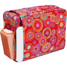 an orange and pink bag with colorful designs on it's front, sitting against a white background