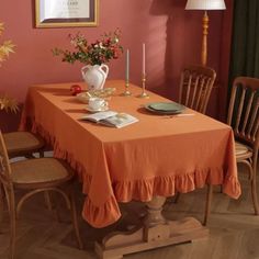 a dining room table with an orange cloth on it